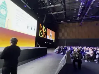 a diverse audience listening to a presentation