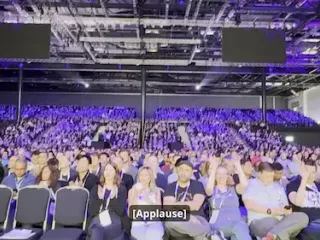 a diverse audience listening to a presentation